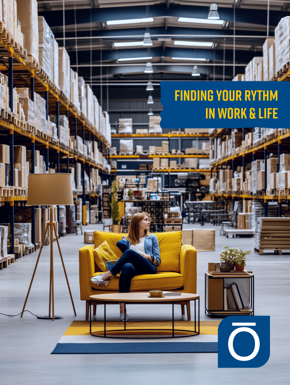 Woman relaxing on a sofa in a warehouse, symbolizing work-life integration.